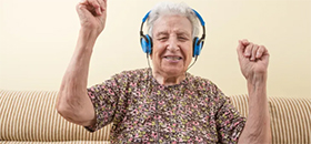 man with dementia listening to music wearing headphones