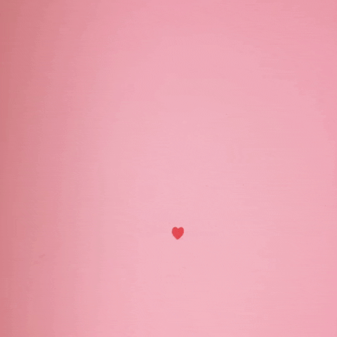 Little red hearts pop up on a pink background to create a larger heart 