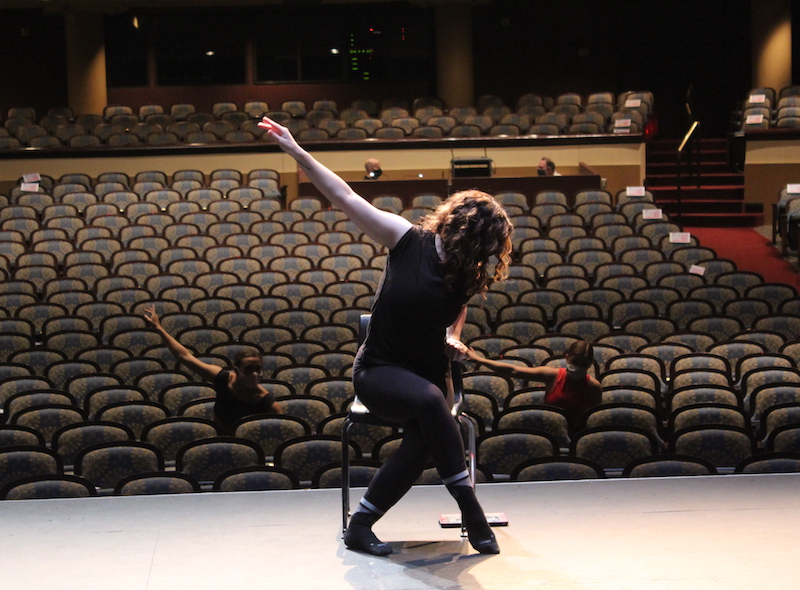 Grace Metcalf demonstrates the choreography for her piece "Retrouvailles" during auditions in RiverCenter''s Bill Heard Auditorium.