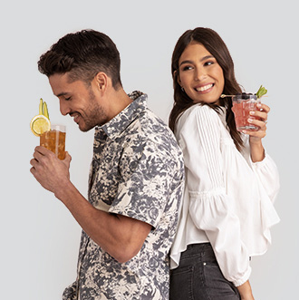 Man and woman sipping cocktails