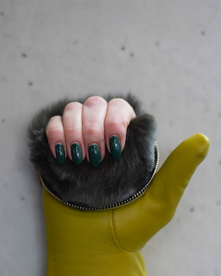 A green leather mitten unzips at the top to showcase gorgeous khaki colored rabbit fur.