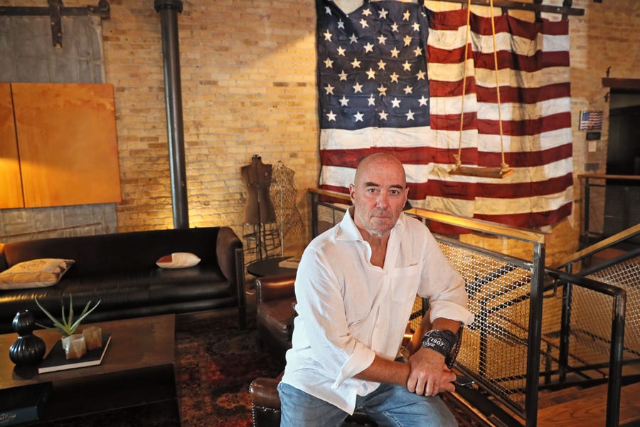 Tim Dixon, shown in the lobby of the Iron Horse Hotel in Milwaukee that he founded, says the downsizing of the Democratic National Convention and the Covid-19 pandemic have hurt his business.