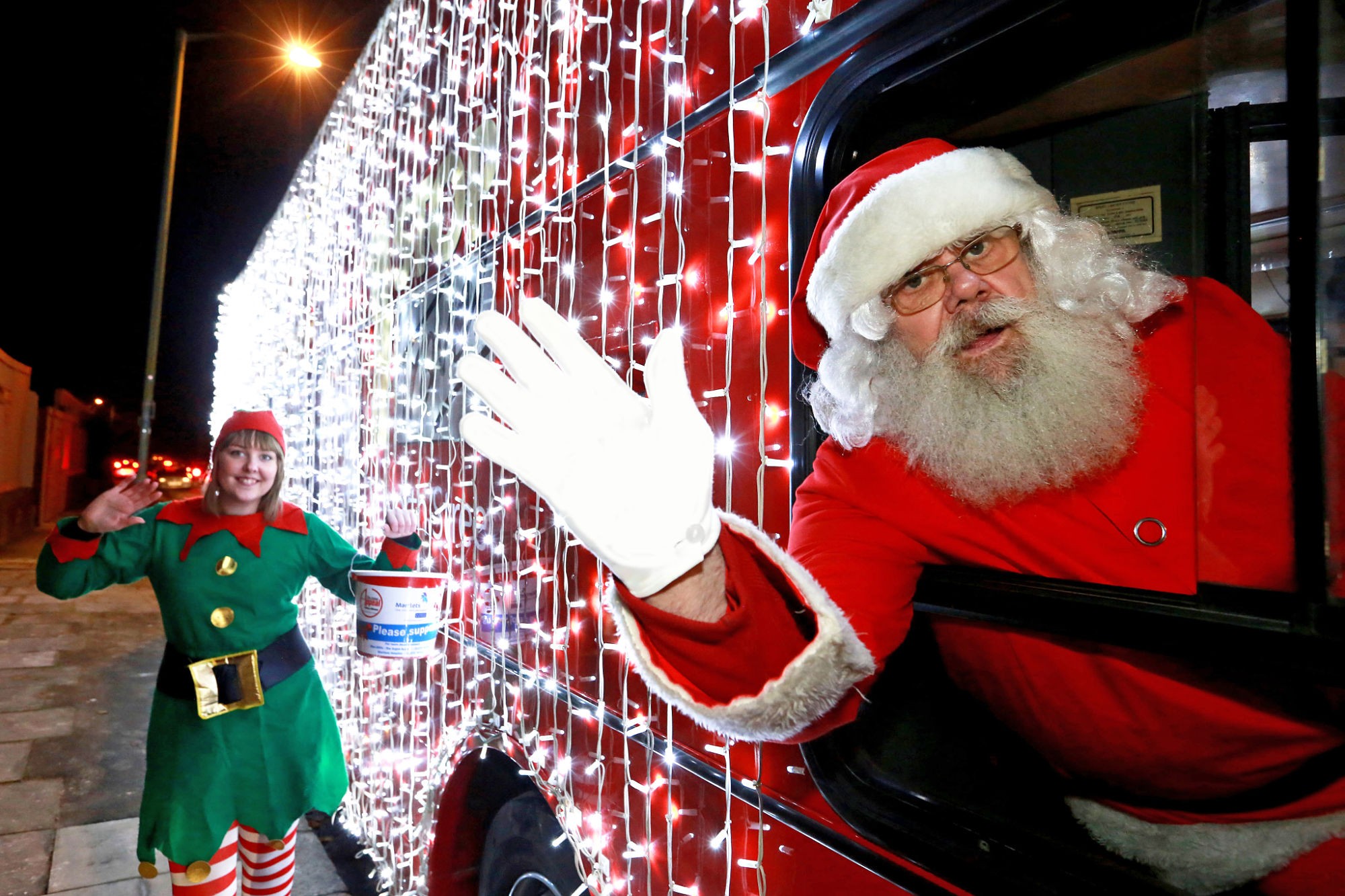Santa and an elf on a bus