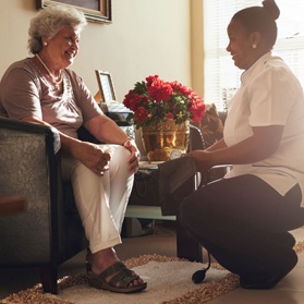 A home health aide visits an older woman