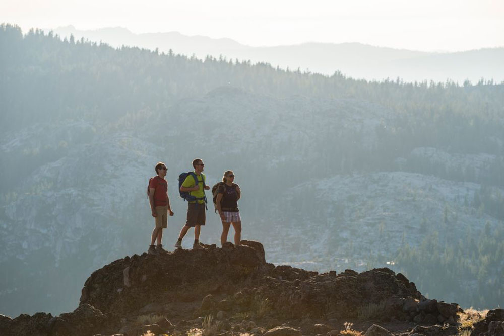 Donate today! Three hikers enjoying public land in the mountains.