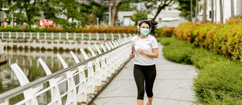 Outdoor runner practicing COVID safety with facemask