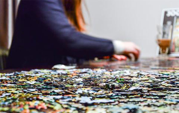 Woman putting puzzle pieces together