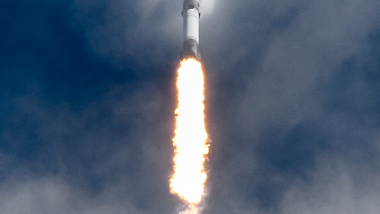 A SpaceX Falcon 9 rocket breaks through the clouds
