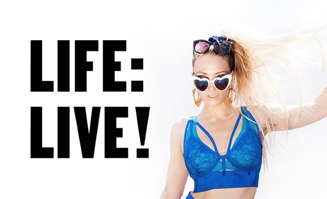 A blonde woman wearing a blue crop top & sunglasses (Lucy McCormick). Text: Life: LIVE!