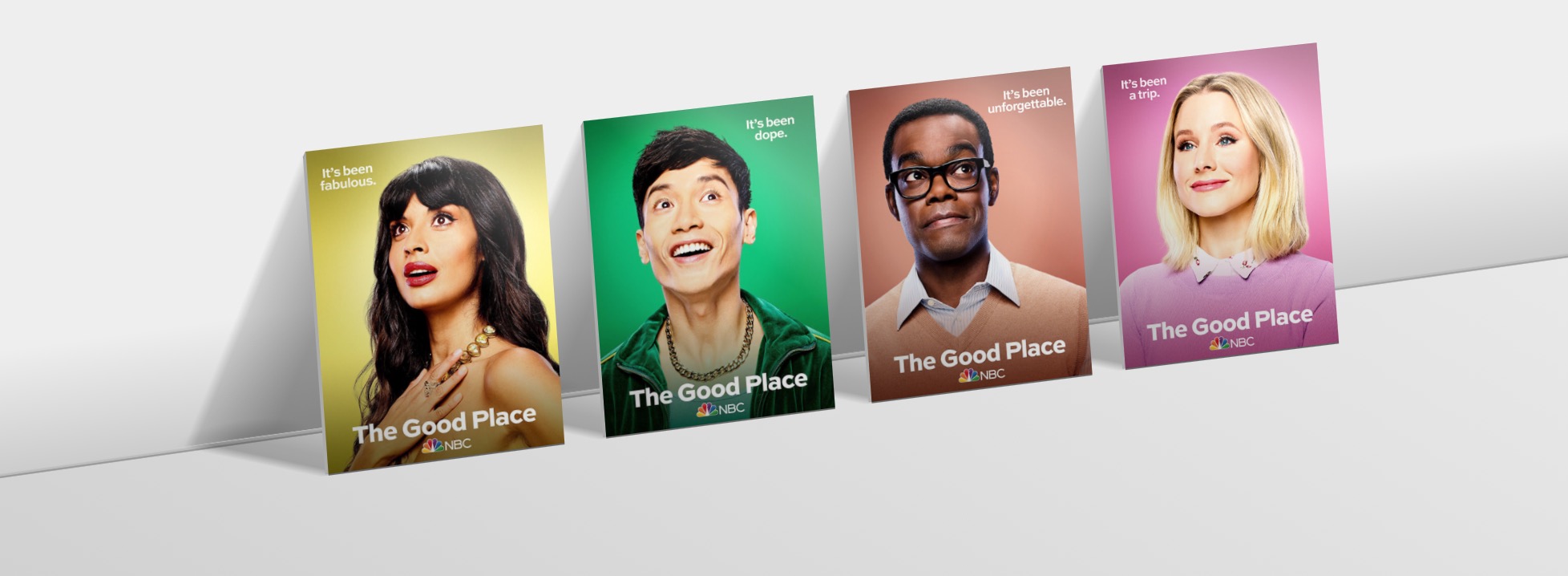 Characters from the Good Place on cards, leaning against a surface with perspective