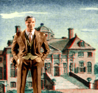 A figurine of a man in a suit stands in front of a backdrop of a house.