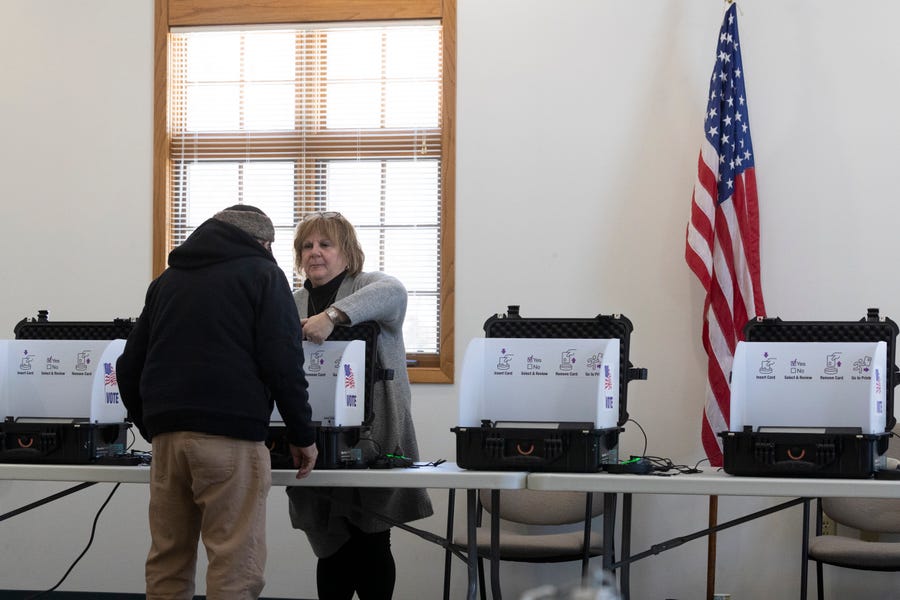 A man is assisted by an election worker in the Town of Fulton. Voters in the town were testing a voting system that uses software made by Microsoft that allows voters to verify that their ballot was counted. Because this is a test, local election officials will be hand counting all paper ballots voters cast to verify the winners.