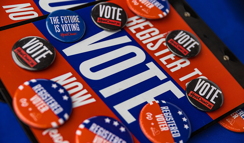 Register to vote merchandise on table.