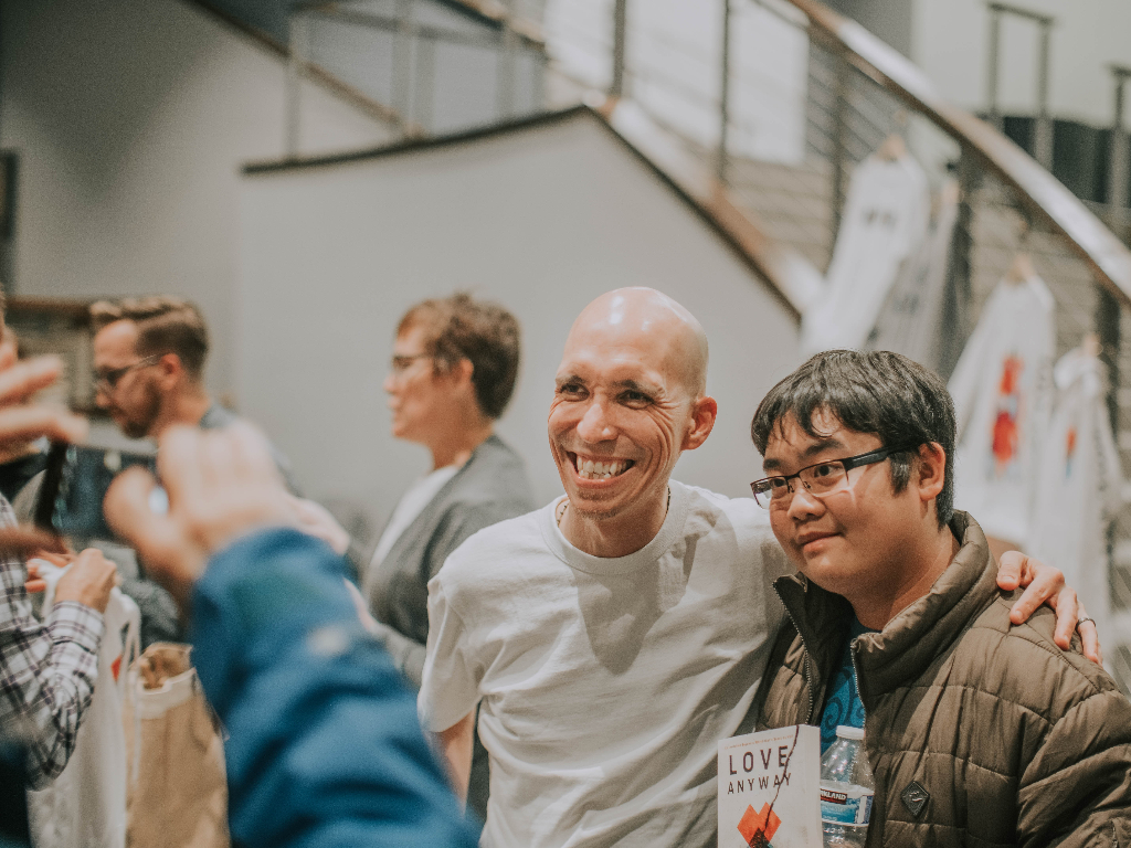 Jeremy Courtney with fan at book tour in Chicago.