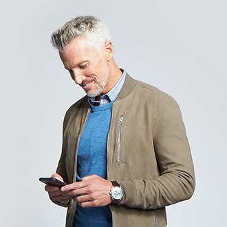 Mature man texting and smiling