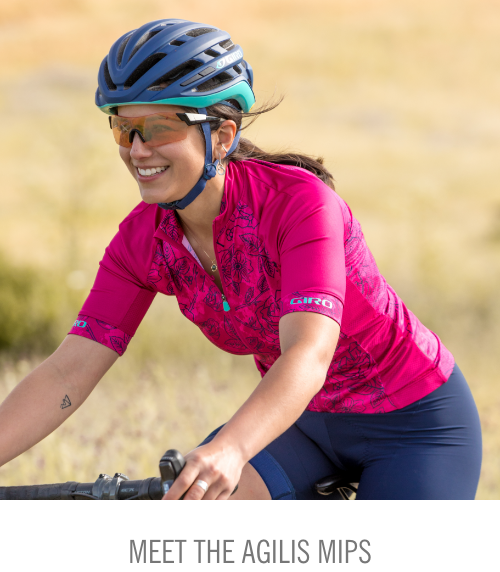 Road rider smiling while riding in Giro Agilis MIPS helmet