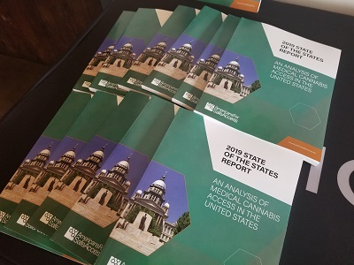 A pile of copies of the 2019 State of the States Report fanned
out for display on a table.