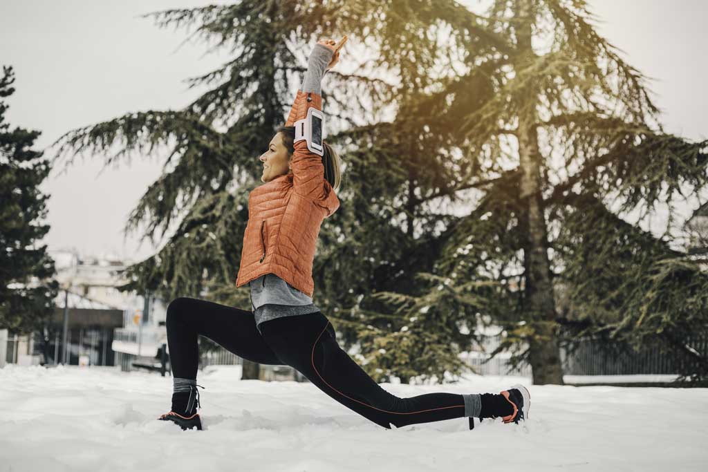 Woman stretching in the snow