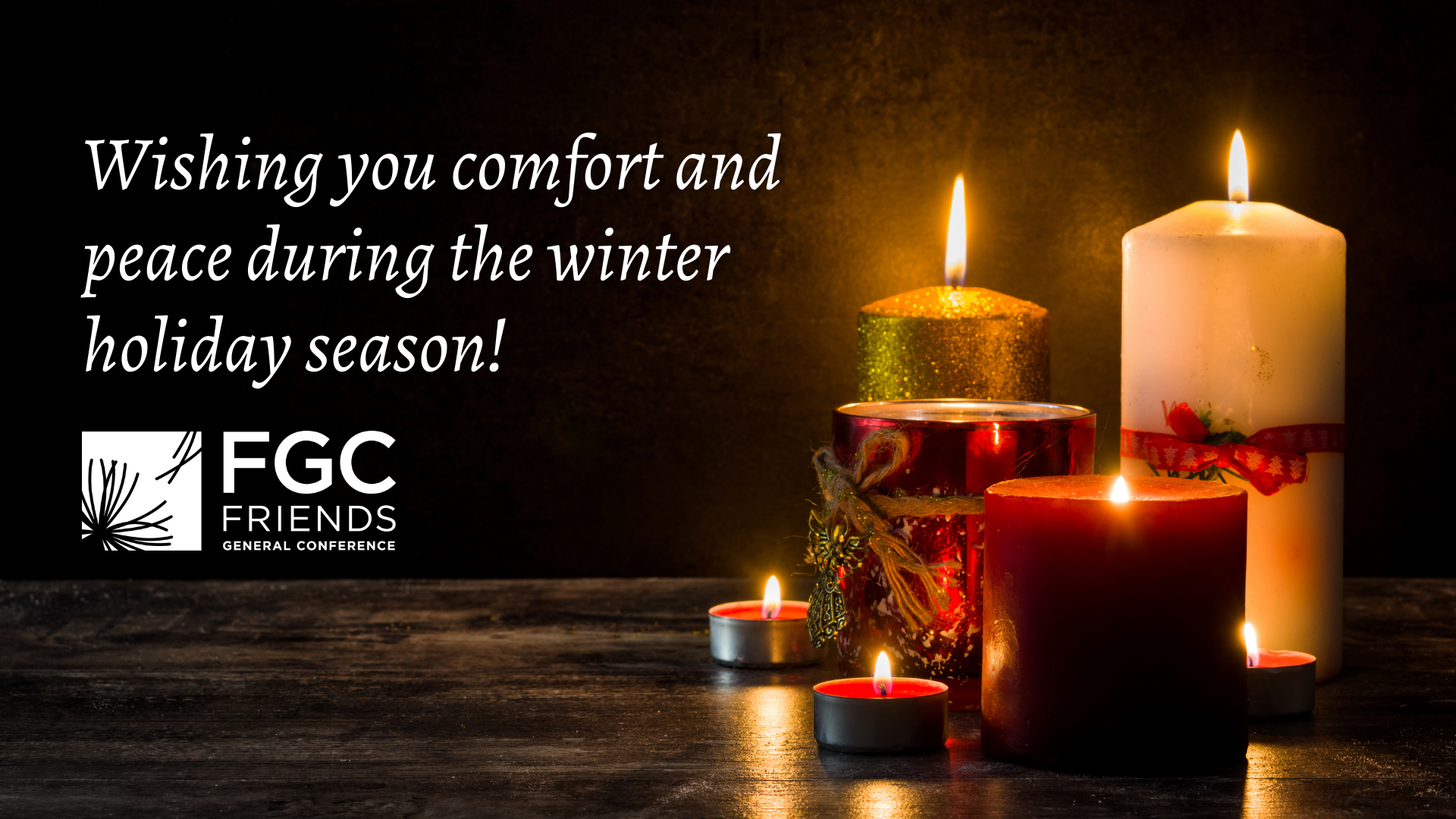 On a table top in a darkened room, several lit candles of various sizes, colors, and adornments light up the space. Next to the candles are the words: "Wishing you comfort and peace during the winter holiday season!" Beneath the words is the FGC logo. 