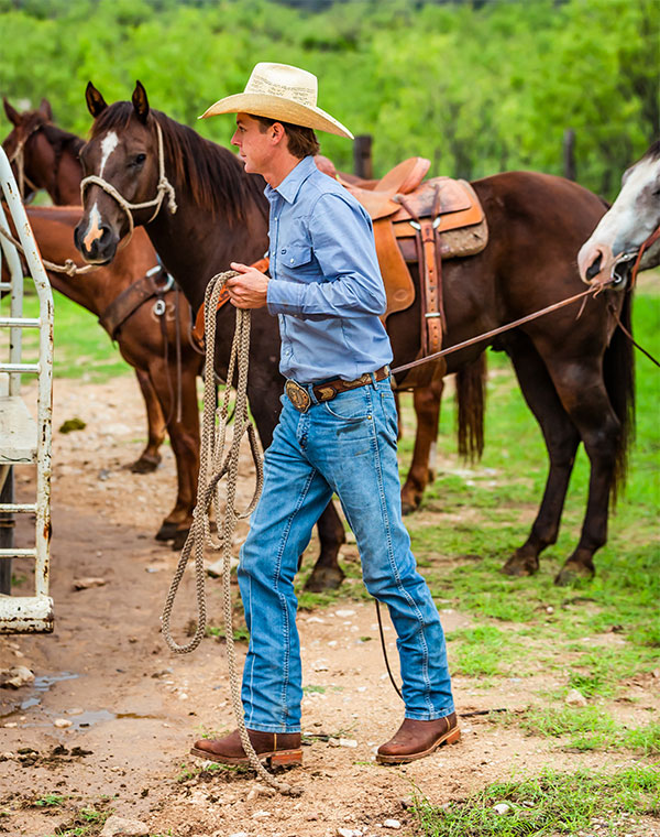 Rancher wearing Justin work boots. Shop The Stampede Collection.
