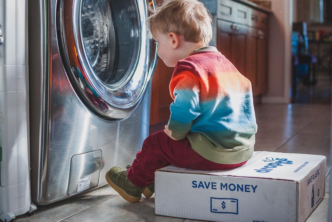 Image of boy looking into front load washer