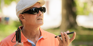 Blind man on a walk, talks to his smartphone