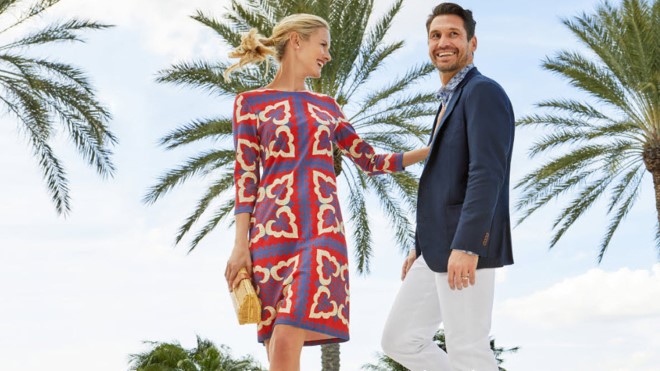 Couple in JMcLaughlin outfits with palm trees in background
