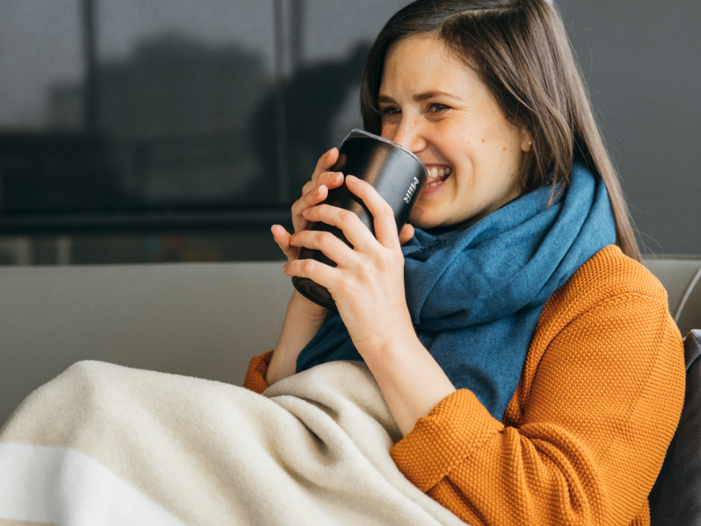 Person holding Black Tumbler.