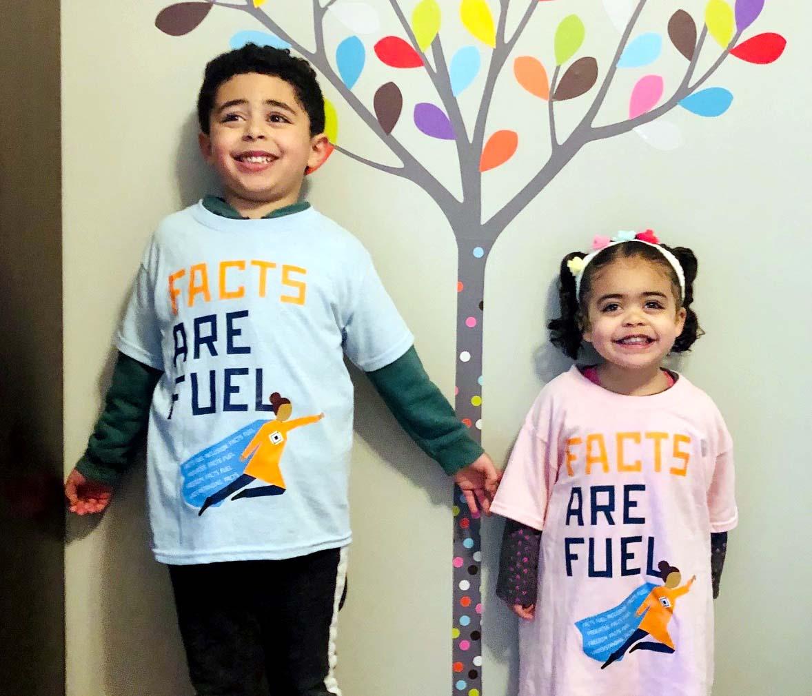 A photo of Marwa''s two kids wearing data girl shirts