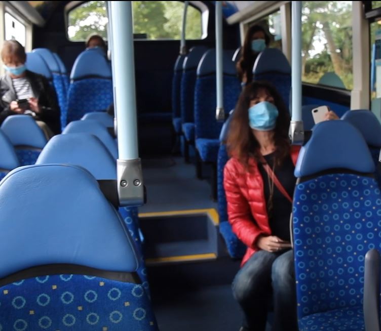 people sitting on a bus wearing coats
