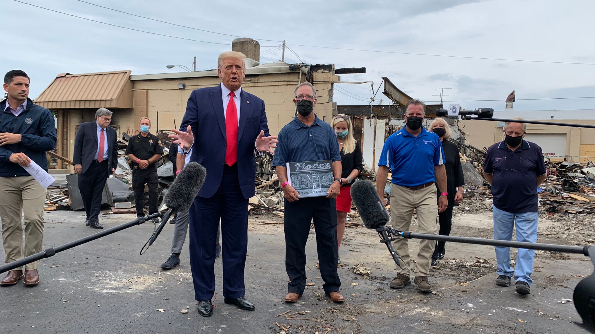 President Donald Trump meets with an owner of B&L Office Furniture in Kenosha, Wisconsin, on Sept. 1, 2020. The business was burned down last week during unrest following the police shooting of Jacob Blake.