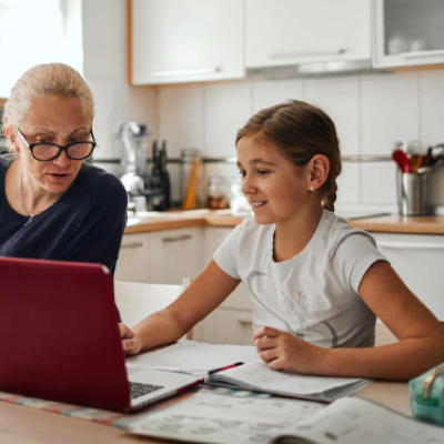 Image of a grandmother helping her grandchild with her homework