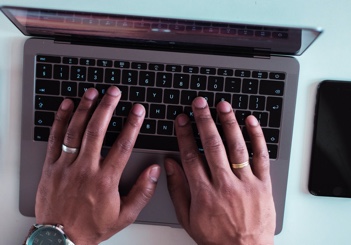 Close up of hands working on a computer