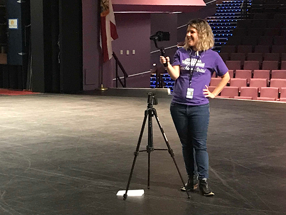 Director of Education and Community Engagement, Kelli Maldonado, stands on the Van Wezel stage while live-streaming a backstage tour to a virtual classroom of local students.