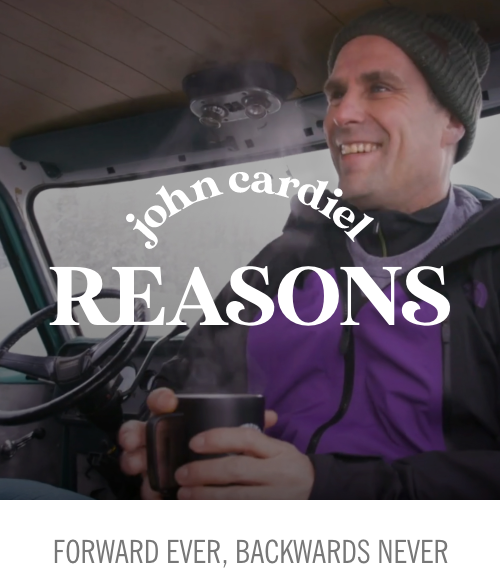 John Cardiel smiling holding a hot beverage
