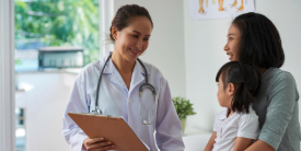 Mother Speaks with Pediatrician Holding Daughter - image