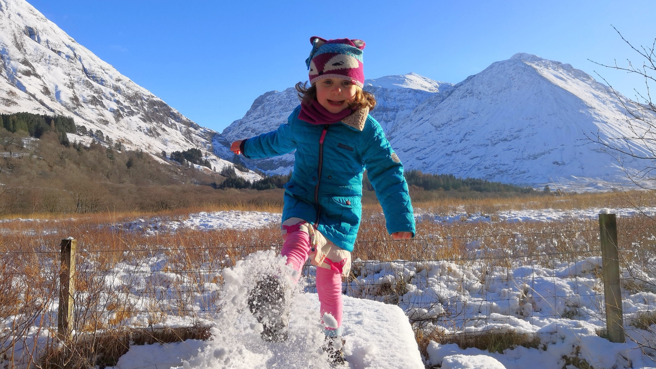 A girl kicks some snow at Glencoe
