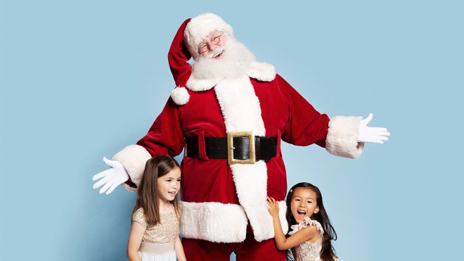 Santa with two young girls on blue background
