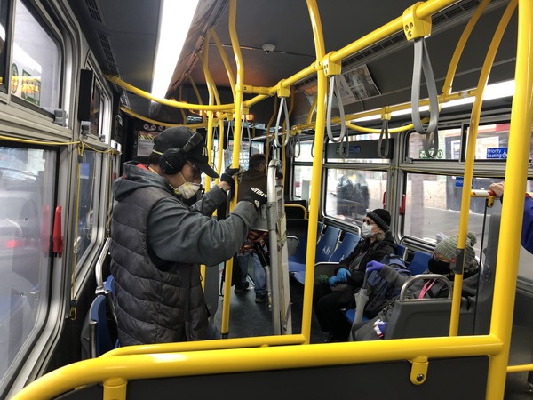 Passengers on the 24 Divisadero bus in San Francisco on April 6 protect themselves with masks. The 24 was among the bus routes considered part of the core service and it wasn't cut.
