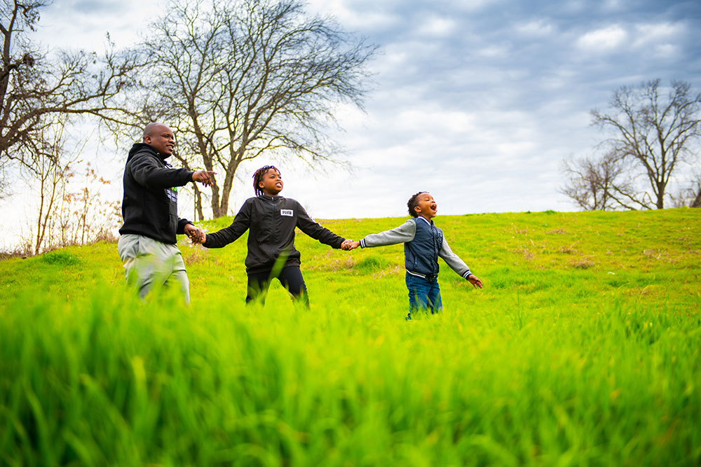 A family walks in a green field