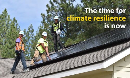 The time for climate resilience is now - text over solar power array with three people in hard hats