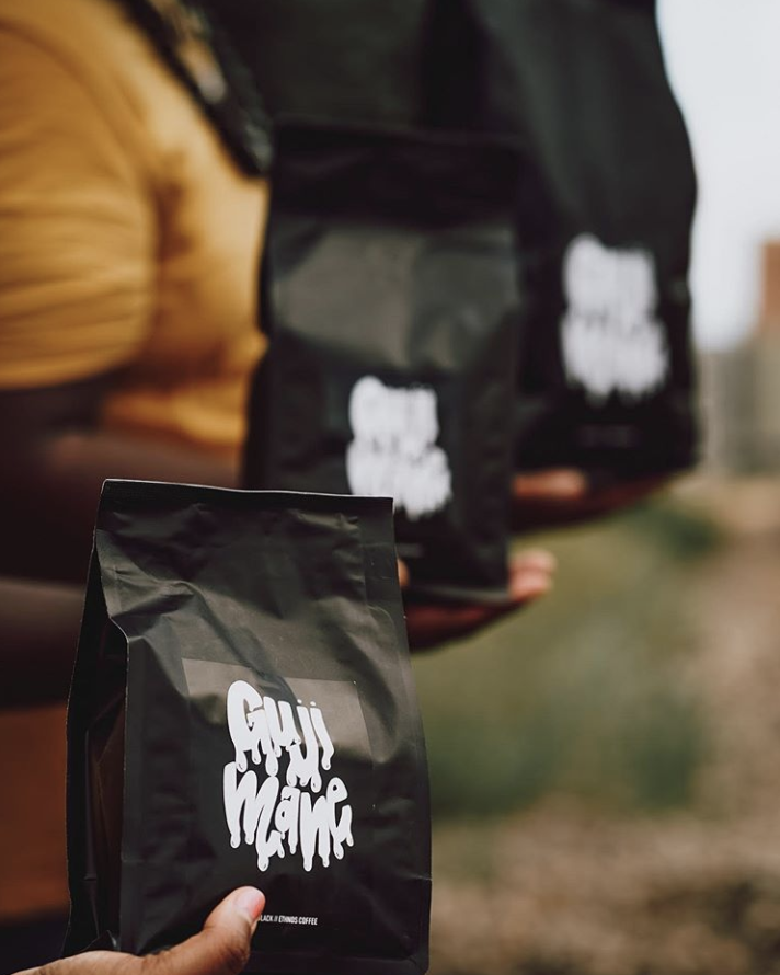 People holding cxffeeblack coffee bags.