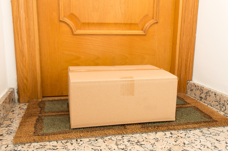 Mail package on the floor of doorway home