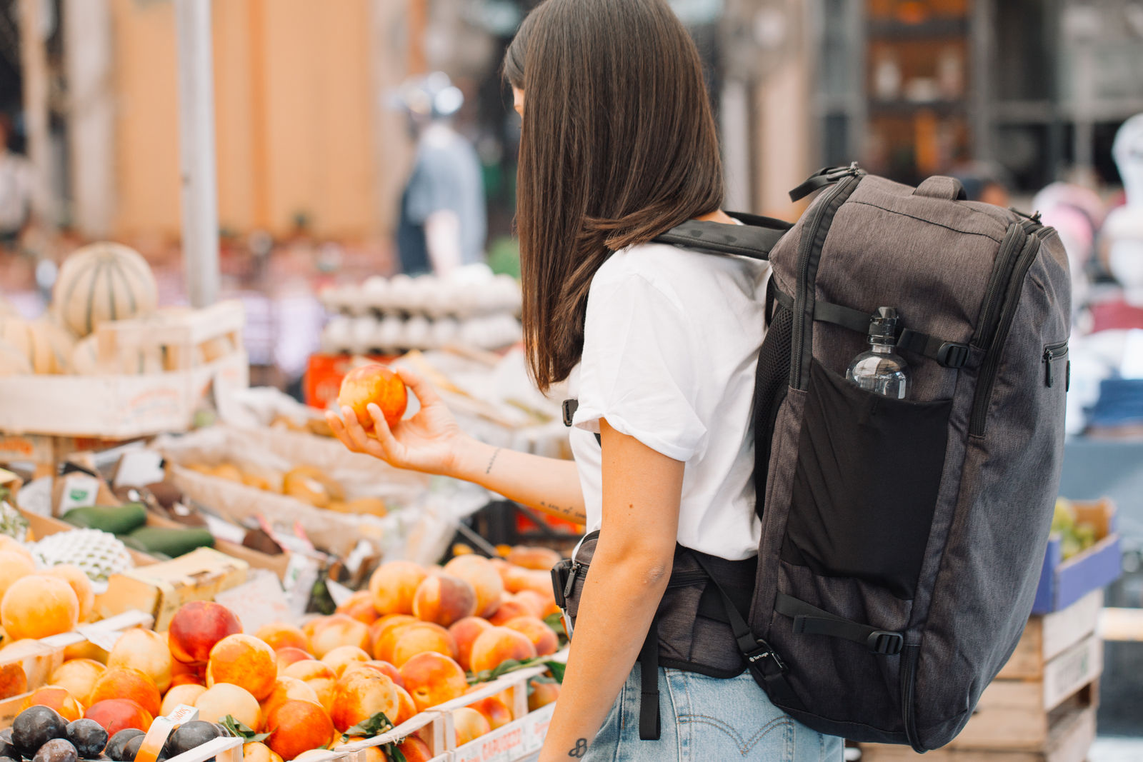 Woman shopping for fruit at a market
