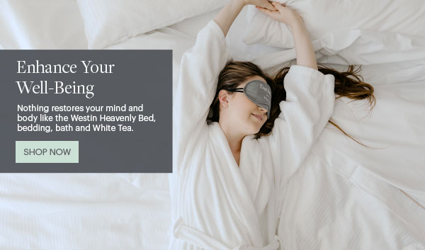 Enhance Your Well-Being - Nothing restores your mind and body like the Westin Heavenly Bed, bedding, bath and White Tea. - Shop Now - Lifestyle Image of Girl in Robe in Bed