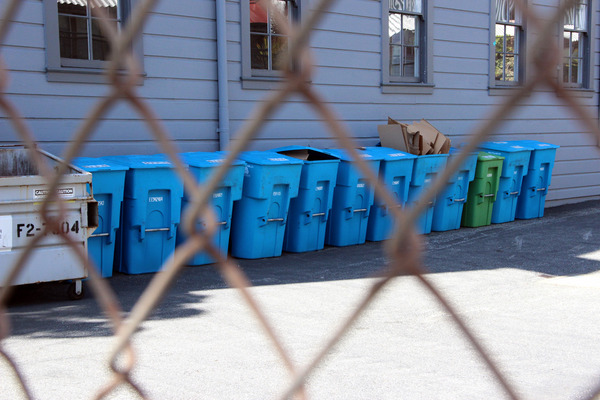 Recycling bins line the side of a building on 18th Street near Folsom.