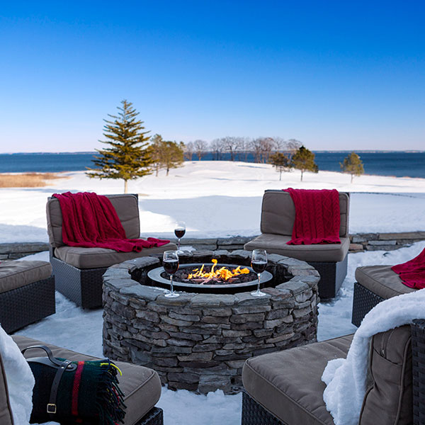 Samoset Resort & Rockport, Maine - Image of an outdoor fire surronded by comfy chairs and glasses of wine