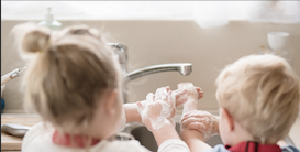Children washing hands together