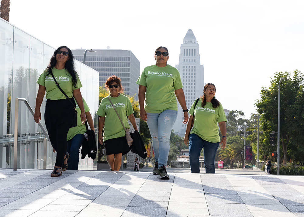 Five women walk up the steps at the Los Angeles City Hall