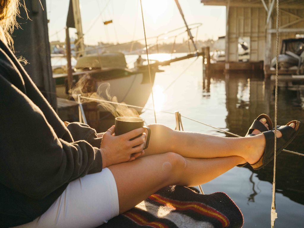 Person sitting on boat holding Camp Cup in Black